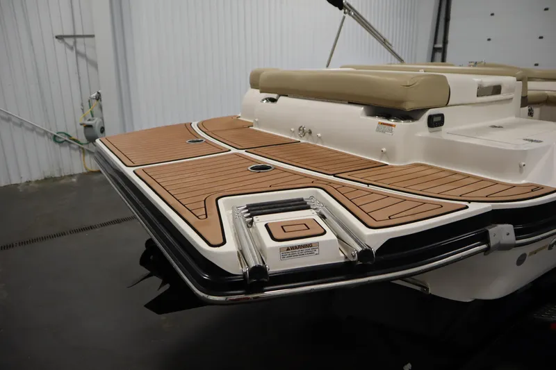 Slide: The Image of 2017 Starcraft 221 STARSTEP boat with teak-style swim platform in a garage. - 49