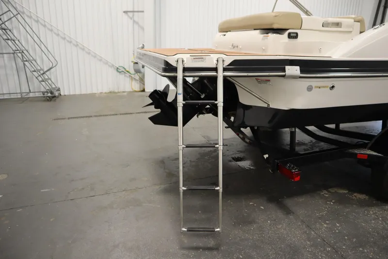 Slide: The Image of 2017 Starcraft 221 STARSTEP boat with ladder in indoor storage facility. - 51