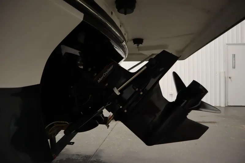 Slide: The Image of 2017 Starcraft 221 STARSTEP boat with MerCruiser outboard motor in a garage. - 52