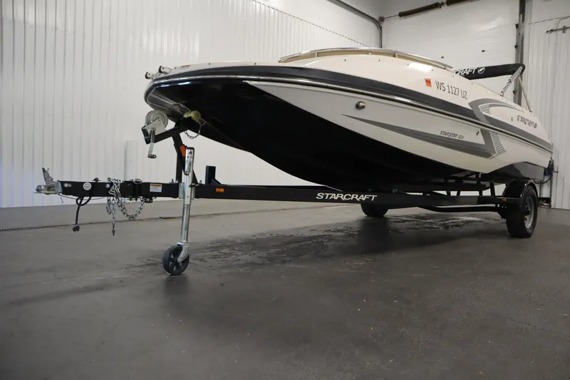 Slide: The Image of 2017 Starcraft 221 STARSTEP boat on trailer in indoor storage facility. - 56