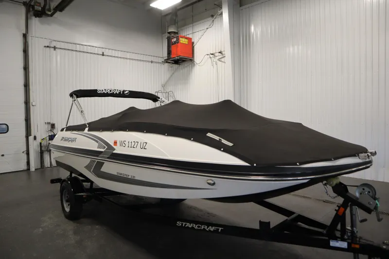 Slide: The Image of 2017 Starcraft 221 STARSTEP boat with cover in indoor storage. - 58