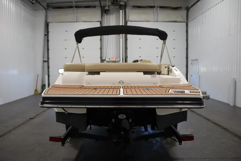 Slide: The Image of 2017 Starcraft 221 STARSTEP boat in a garage, rear view with teak deck. - 6