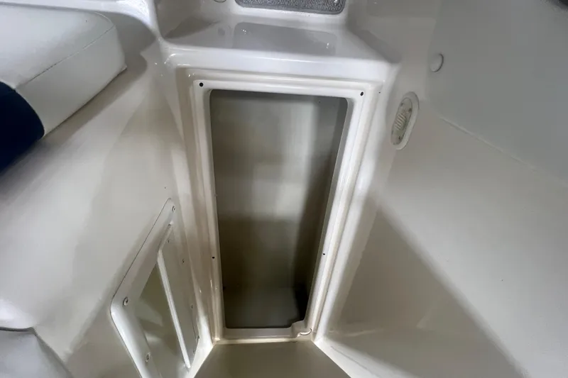 Slide: The Image of Interior storage compartment of a 2000 Rinker 212 Captiva Bowrider boat. - 10