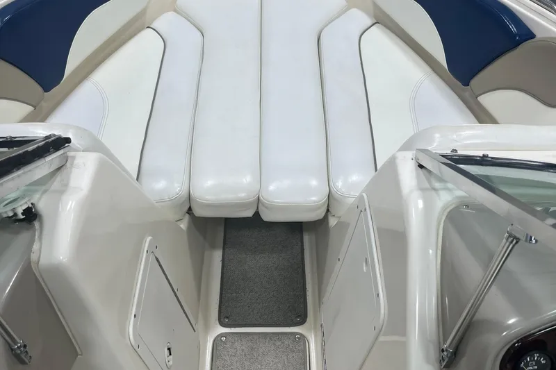 Slide: The Image of 2000 Rinker 212 Captiva Bowrider interior with white and blue seating. - 11