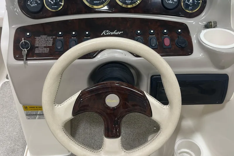 Slide: The Image of Steering wheel and dashboard of 2000 Rinker 212 Captiva Bowrider boat. - 13