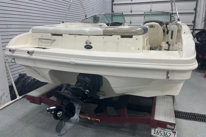 Slide: The Image of 2000 Rinker 212 Captiva Bowrider in garage, rear view showing propeller and interior. - 18
