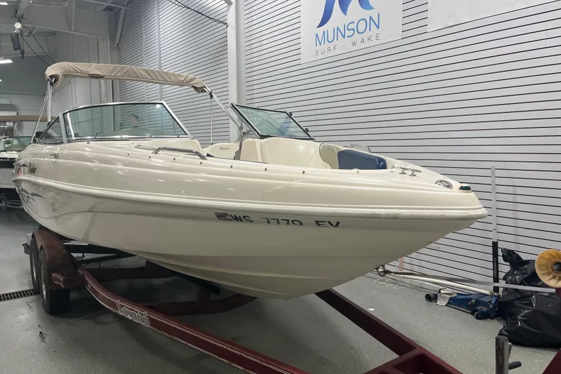 Slide: The Image of 2000 Rinker 212 Captiva Bowrider boat on trailer in showroom, Munson Surf & Wake. - 19