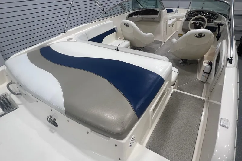 Slide: The Image of Interior of a 2000 Rinker 212 Captiva Bowrider boat with white and blue seating. - 6