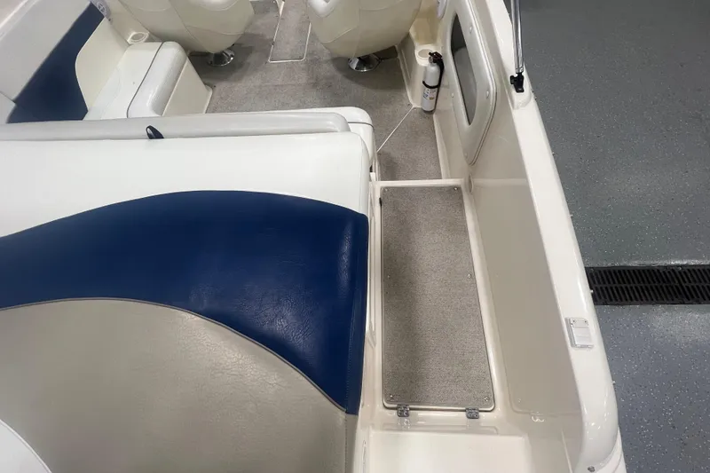 Slide: The Image of Interior of 2000 Rinker 212 Captiva Bowrider with blue and white seating. - 7