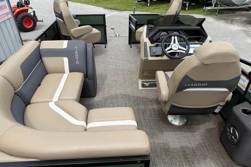 Slide: The Image of 2024 Viaggio 18 FISH boat interior with beige seating and modern steering console. - 17
