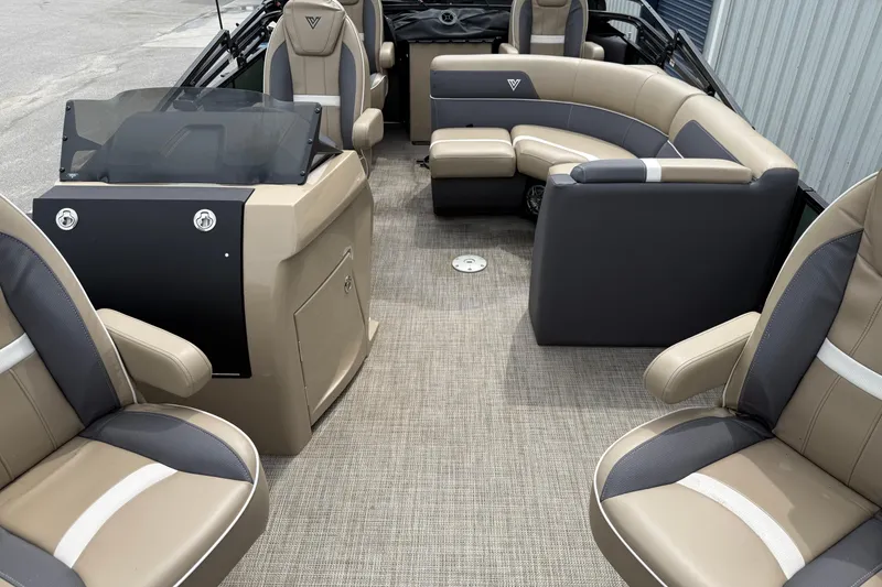 Slide: The Image of 2024 Viaggio 18 FISH boat interior with beige and gray seating, steering console, and carpeted floor. - 5
