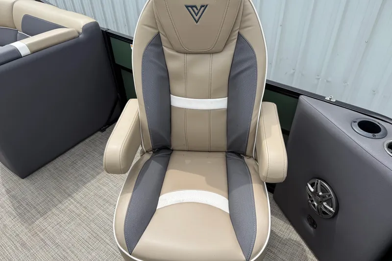 Slide: The Image of 2024 Viaggio 18 FISH boat seat with beige and gray upholstery, cup holder, and speaker. - 6
