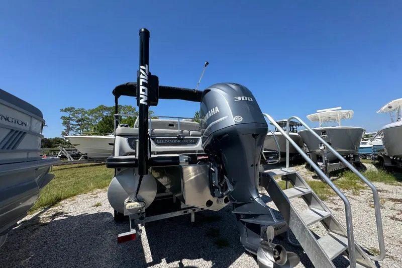 Slide: The Image of 2021 Bennington 25 RTSB boat with Yamaha 300 engine, parked outdoors. - 10
