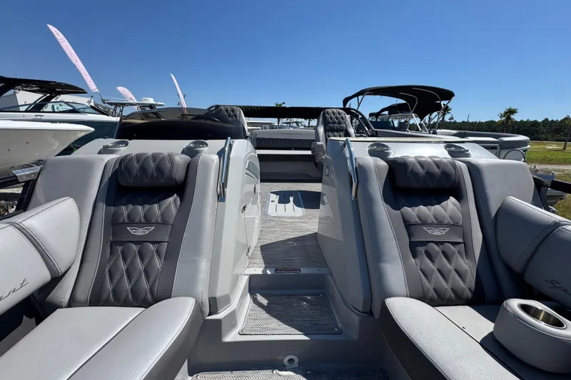 Slide: The Image of 2021 Bennington 25 RTSB boat interior with luxurious seating and sleek design under clear blue sky. - 19