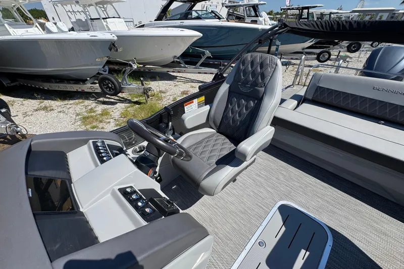 Slide: The Image of 2021 Bennington 25 RTSB boat interior with luxurious seating and control panel. - 20