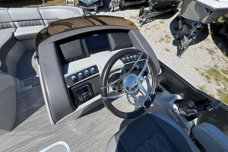 Slide: The Image of 2021 Bennington 25 RTSB boat dashboard with steering wheel and control panel. - 21