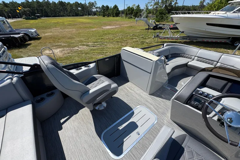 Slide: The Image of 2021 Bennington 25 RTSB boat interior with plush seating and modern controls. - 24