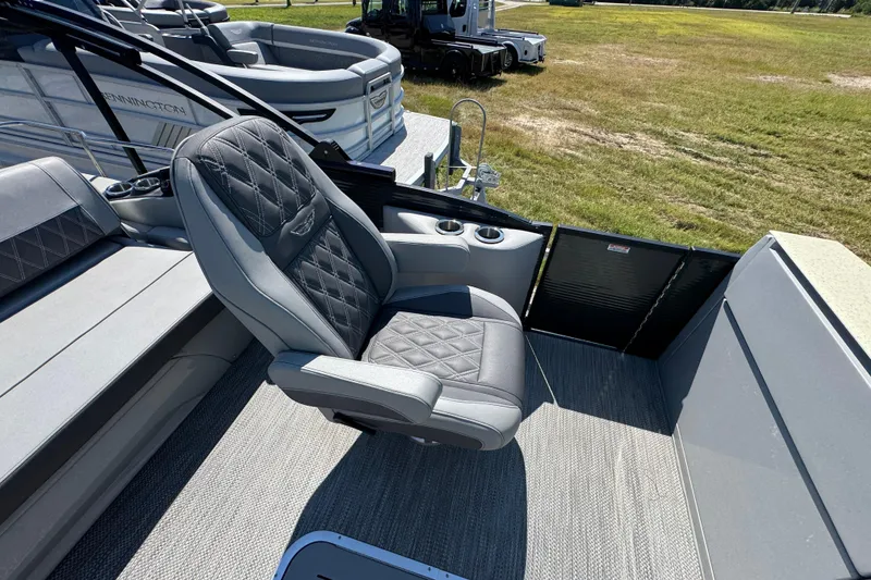 Slide: The Image of 2021 Bennington 25 RTSB boat interior with luxurious seating and cup holders. - 25
