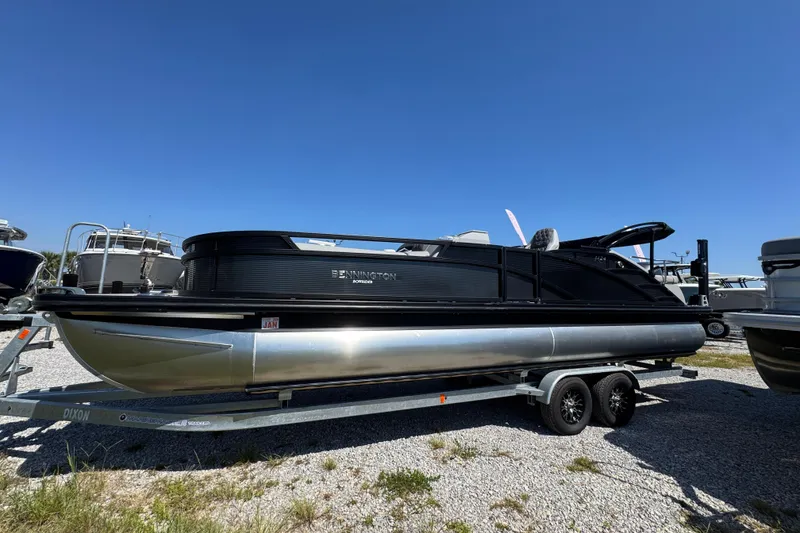 Slide: The Image of 2021 Bennington 25 RTSB pontoon boat on trailer under clear blue sky. - 8