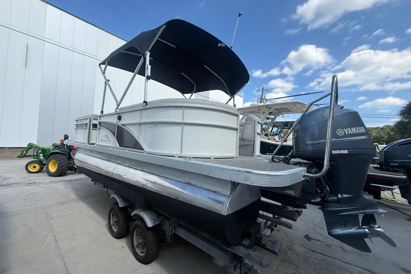 Slide: The Image of 2016 Bennington 22 SSRX pontoon boat with Yamaha outboard motor on trailer. - 1