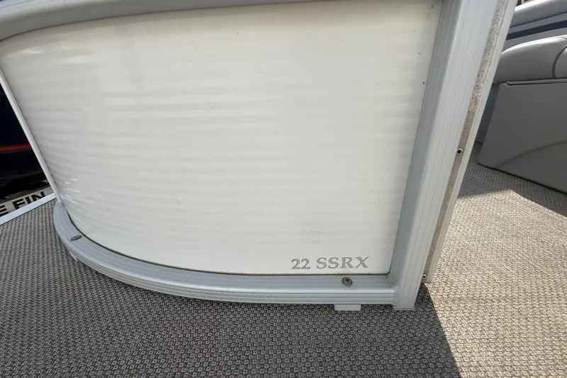 Slide: The Image of 2016 Bennington 22 SSRX pontoon boat detail, featuring side panel and model name. - 14