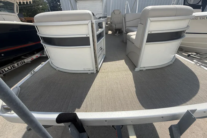 Slide: The Image of 2016 Bennington 22 SSRX pontoon boat interior with seating and carpeted deck. - 15