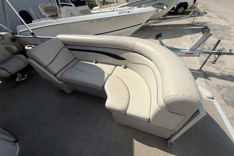 Slide: The Image of 2016 Bennington 22 SSRX boat interior with beige seating and carpeted flooring. - 16