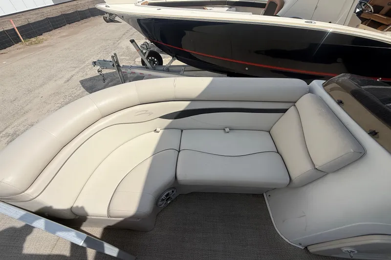 Slide: The Image of 2016 Bennington 22 SSRX boat interior with beige seating and carpeted flooring. - 17