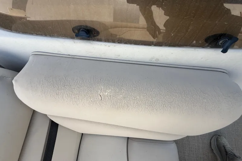 Slide: The Image of Worn seat cushion on a 2016 Bennington 22 SSRX boat, showing signs of aging. - 18
