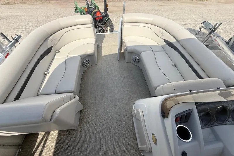 Slide: The Image of 2016 Bennington 22 SSRX pontoon boat interior with beige seating and carpeted floor. - 19