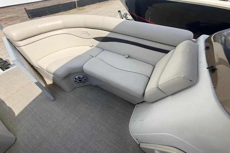 Slide: The Image of 2016 Bennington 22 SSRX boat interior with beige seating and speaker. - 20