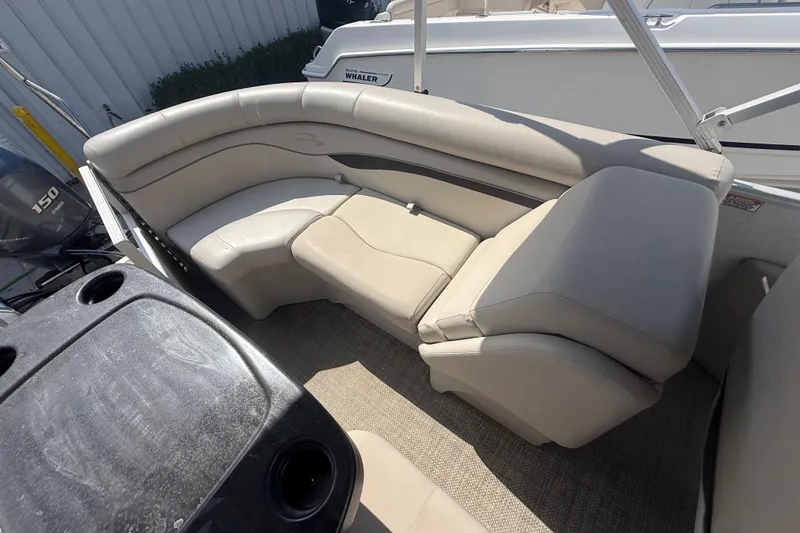 Slide: The Image of 2016 Bennington 22 SSRX boat interior with beige seating and cup holders. - 26