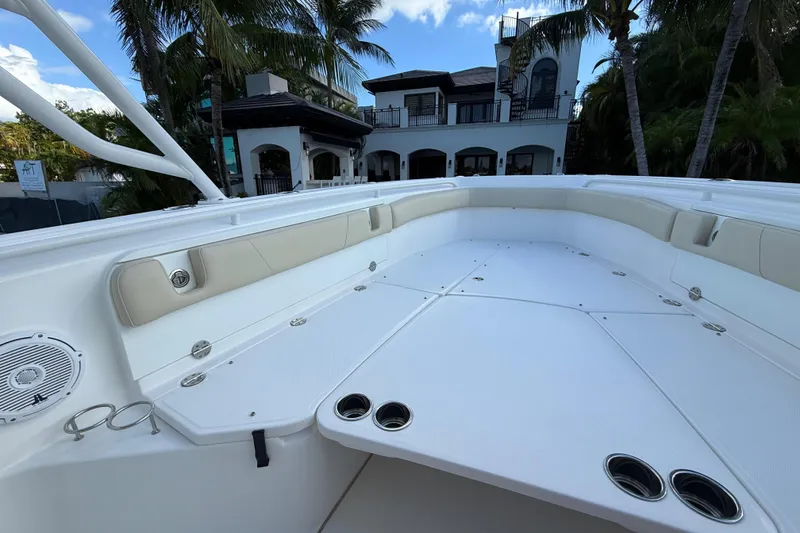Slide: The Image of 2018 Everglades 355 Center Console boat deck with luxurious seating and cup holders. - 14