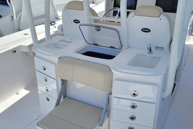 Slide: The Image of 2018 Everglades 355 Center Console boat interior with seating, storage, and sink. - 16