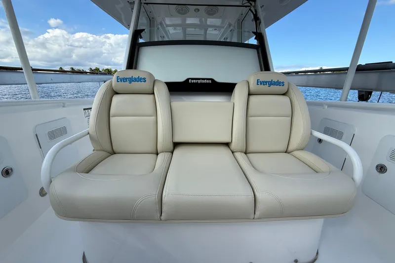 Slide: The Image of 2018 Everglades 355 Center Console boat with beige seating, ocean view background. - 19
