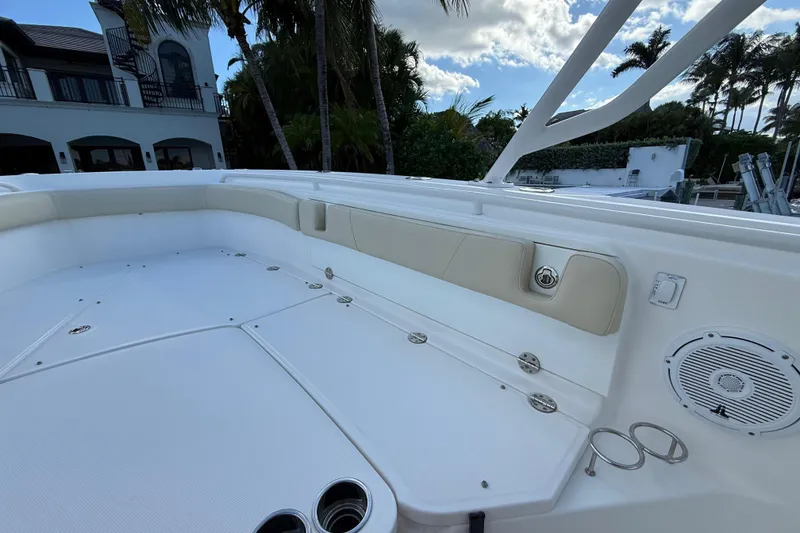 Slide: The Image of 2018 Everglades 355 Center Console boat interior with seating and cup holders. - 22