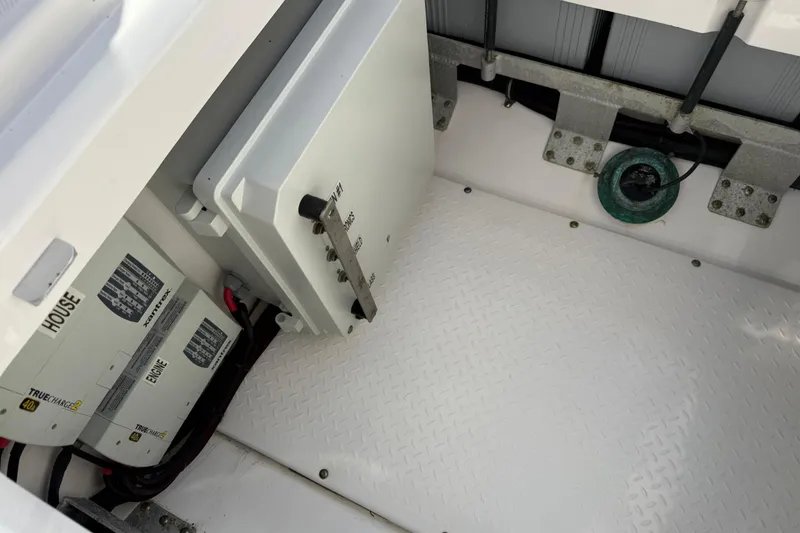 Slide: The Image of 2018 Everglades 355 Center Console battery compartment with electrical components and wiring. - 26