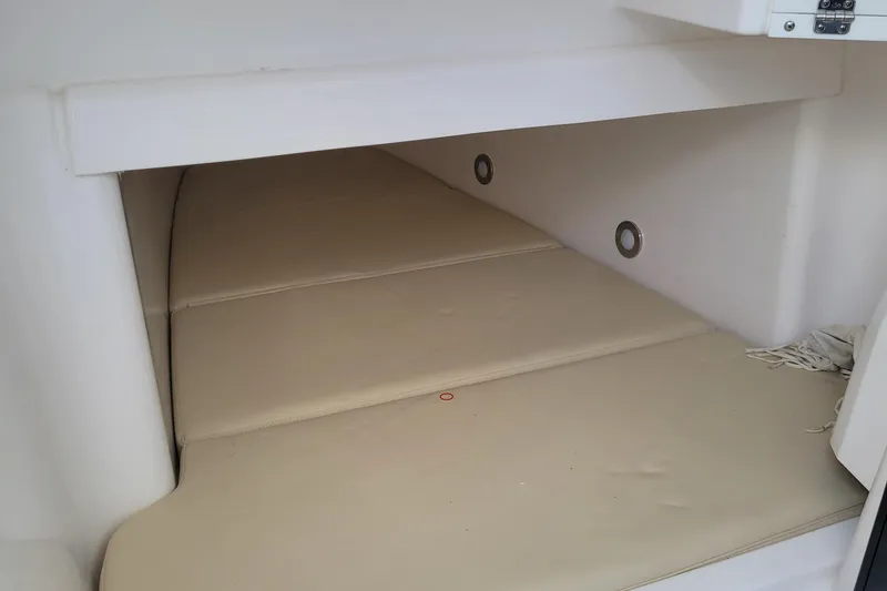 Slide: The Image of 2018 Everglades 355 Center Console cabin interior with beige cushions. - 29