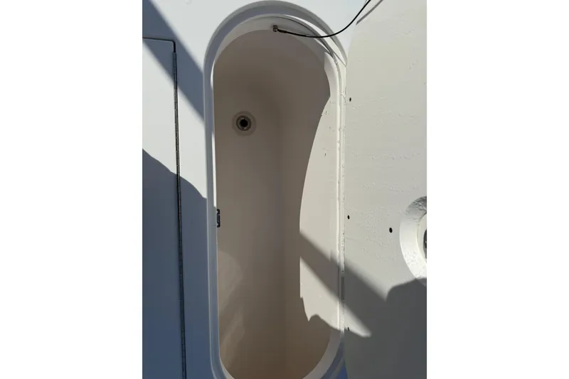Slide: The Image of Open storage compartment on 2018 Everglades 355 Center Console boat. - 32