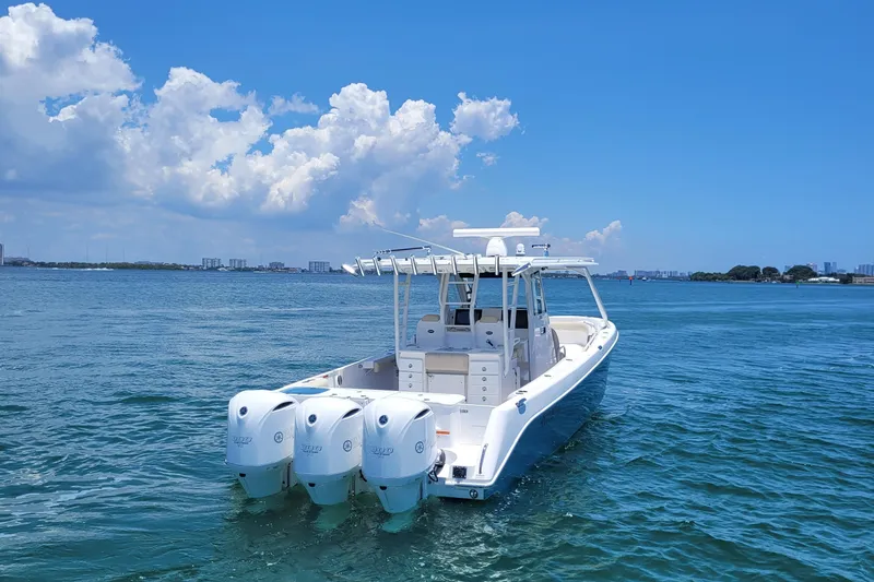 Slide: The Image of 2018 Everglades 355 Center Console boat on calm blue water under a clear sky. - 5