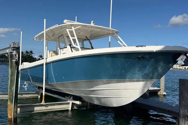 Slide: The Image of 2018 Everglades 355 Center Console boat docked on a sunny day. - 6