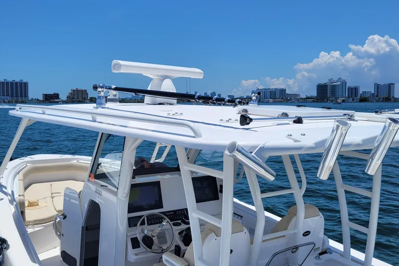 Slide: The Image of 2018 Everglades 355 Center Console boat on water, featuring advanced navigation equipment. - 9
