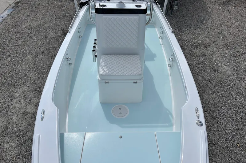 Slide: The Image of 2025 Dragonfly Boatworks Spanish Wells 21, sleek design with white seating and light blue deck. - 11