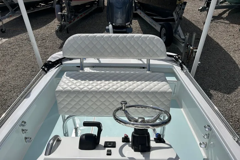 Slide: The Image of 2025 Dragonfly Boatworks Spanish Wells 21 helm with quilted seating and steering wheel. - 13