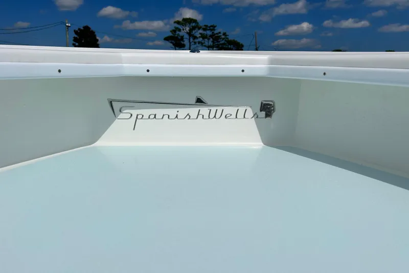 Slide: The Image of 2025 Dragonfly Boatworks Spanish Wells 21 boat deck under a clear blue sky. - 19