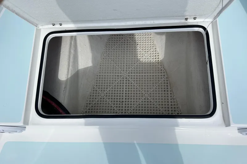 Slide: The Image of Open storage compartment on 2025 Dragonfly Boatworks Spanish Wells 21 boat. - 22