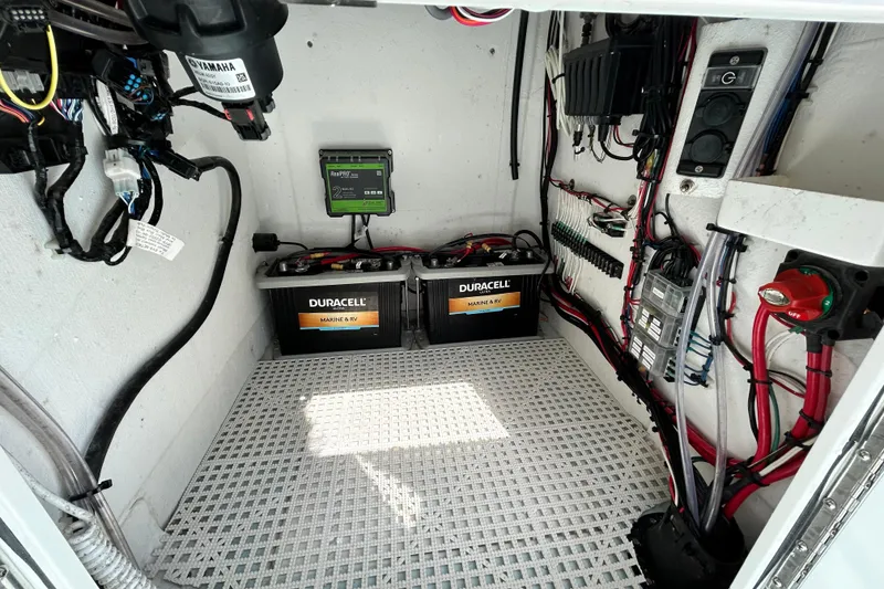 Slide: The Image of Electrical compartment of 2025 Dragonfly Boatworks Spanish Wells 21 with batteries and wiring. - 24