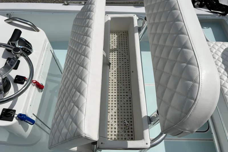 Slide: The Image of 2025 Dragonfly Boatworks Spanish Wells 21 helm with quilted seating and steering controls. - 27