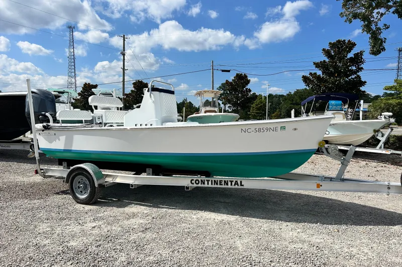 Slide: The Image of 2025 Dragonfly Boatworks Spanish Wells 21 on trailer, parked outdoors under blue sky. - 3