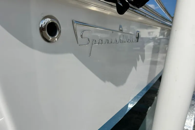 Slide: The Image of 2025 Dragonfly Boatworks Spanish Wells 21 boat, close-up of logo and hull detail. - 6